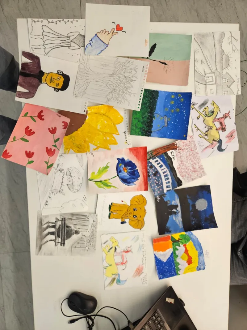 Paintings by the team laid out on a table