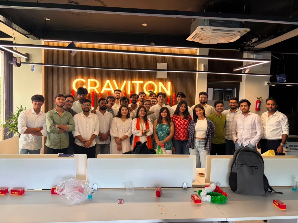 The Graviton team gathered under the office sign