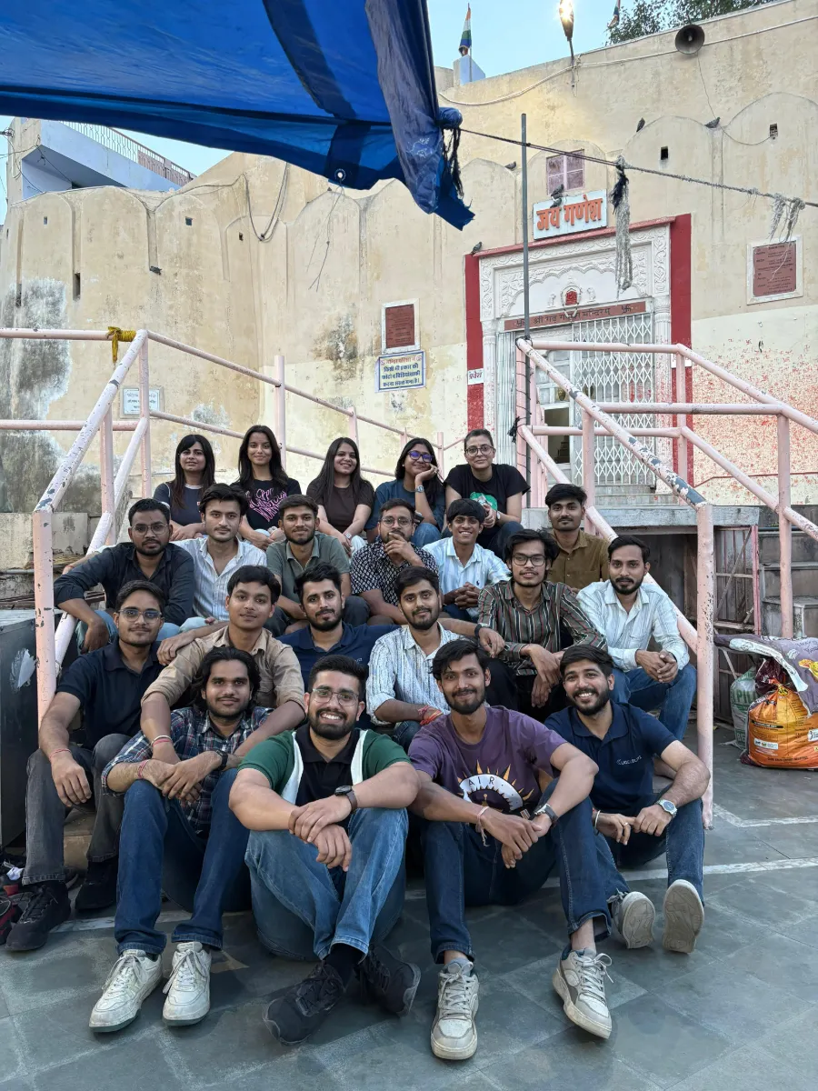 The team on the steps at an outing